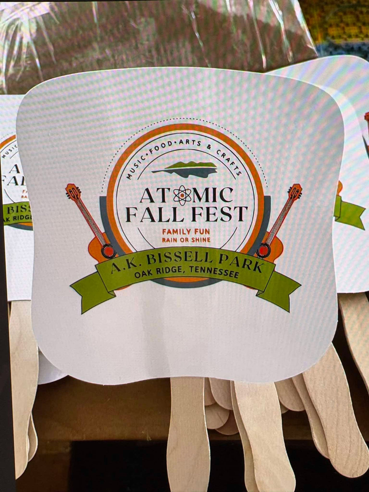 Close-up of a custom printed Atomic Fall Fest hand fan for A.K. Bissell Park in Oak Ridge, Tennessee, by United Branding Supply